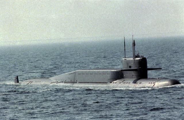 Aerial starboard view of a Russian Navy Delta III nuclear submarine on the ocean surface.