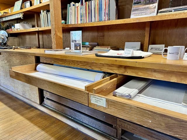 Interior of Paul Schweiker House and Studio with rolled blueprints and art supplies.