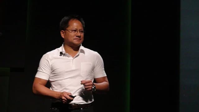 Jensen Huang, CEO of Nvidia, speaking on stage at a conference event.