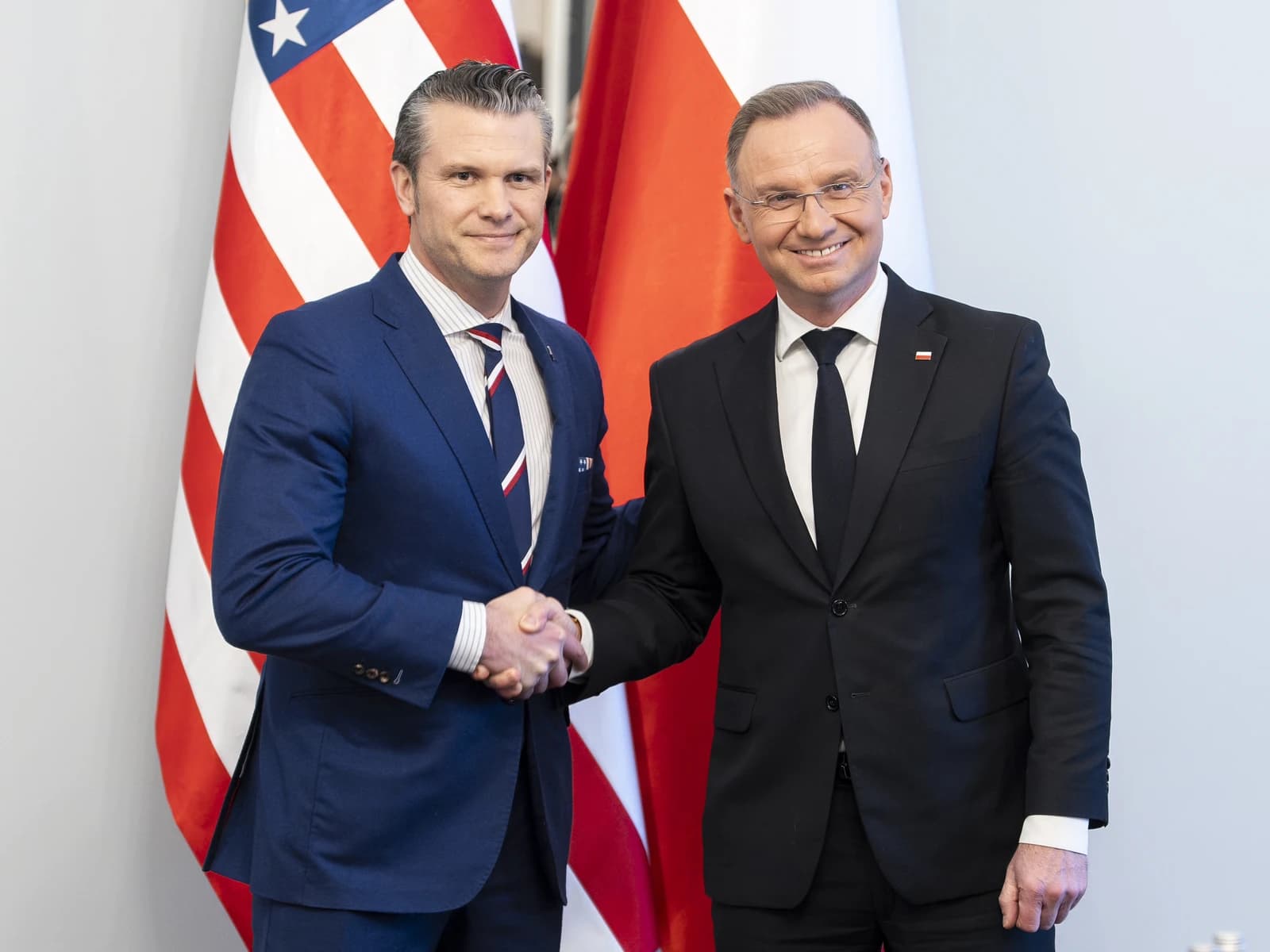 Pete Hegseth and Polish President Andrzej Duda shake hands at the Presidential Palace.