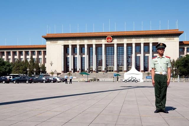 Chinese soldier stands guard in front of the Great Hall of the People, Tiananmen Square.