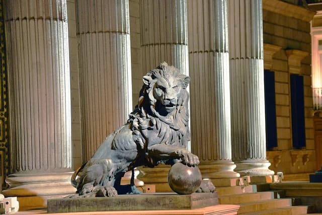 Bronze lion statue, part of the Lions of the Congress, in Madrid, Spain.