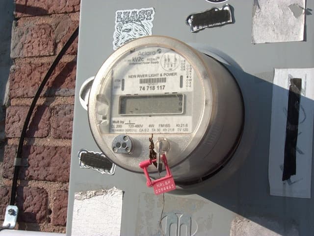 An Aclara kV2c FITZALL 3-phase smart electricity meter mounted on a wall.