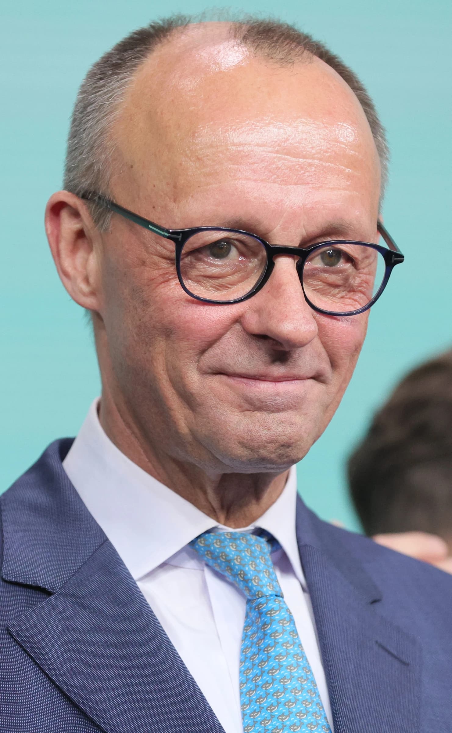 Friedrich Merz, leader of the CDU, smiling at a political event.