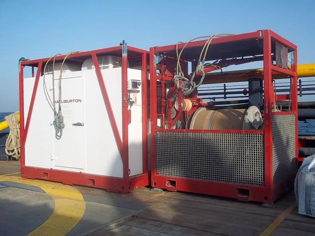 Halliburton well logging cabin and wire spool on an offshore platform.