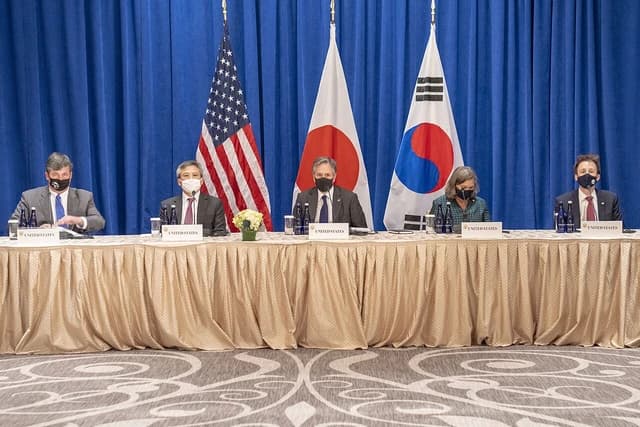 Secretary Blinken, the Japanese Foreign Minister, and the Republic of Korea Foreign Minister seated at a table.