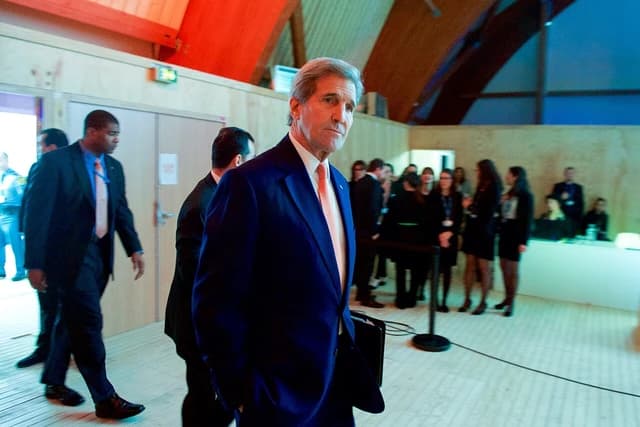Secretary Kerry enters the Plenary Hall at the COP21 Climate Change Conference.