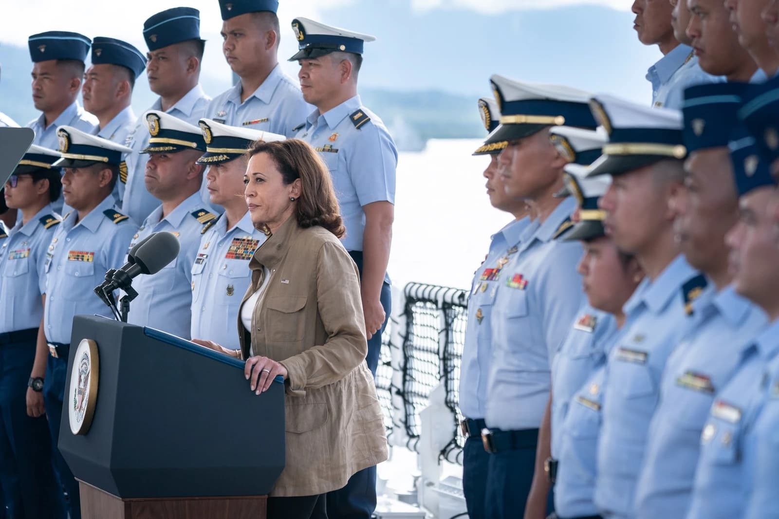 Vice President Kamala Harris speaking at a podium on a Philippine Coast Guard patrol ship in Puerto Princesa City.