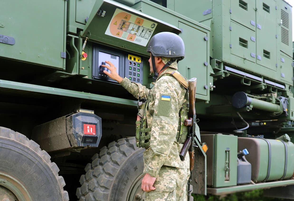 Ukrainian soldier operating an IRIS-T SLM air defense system control panel.