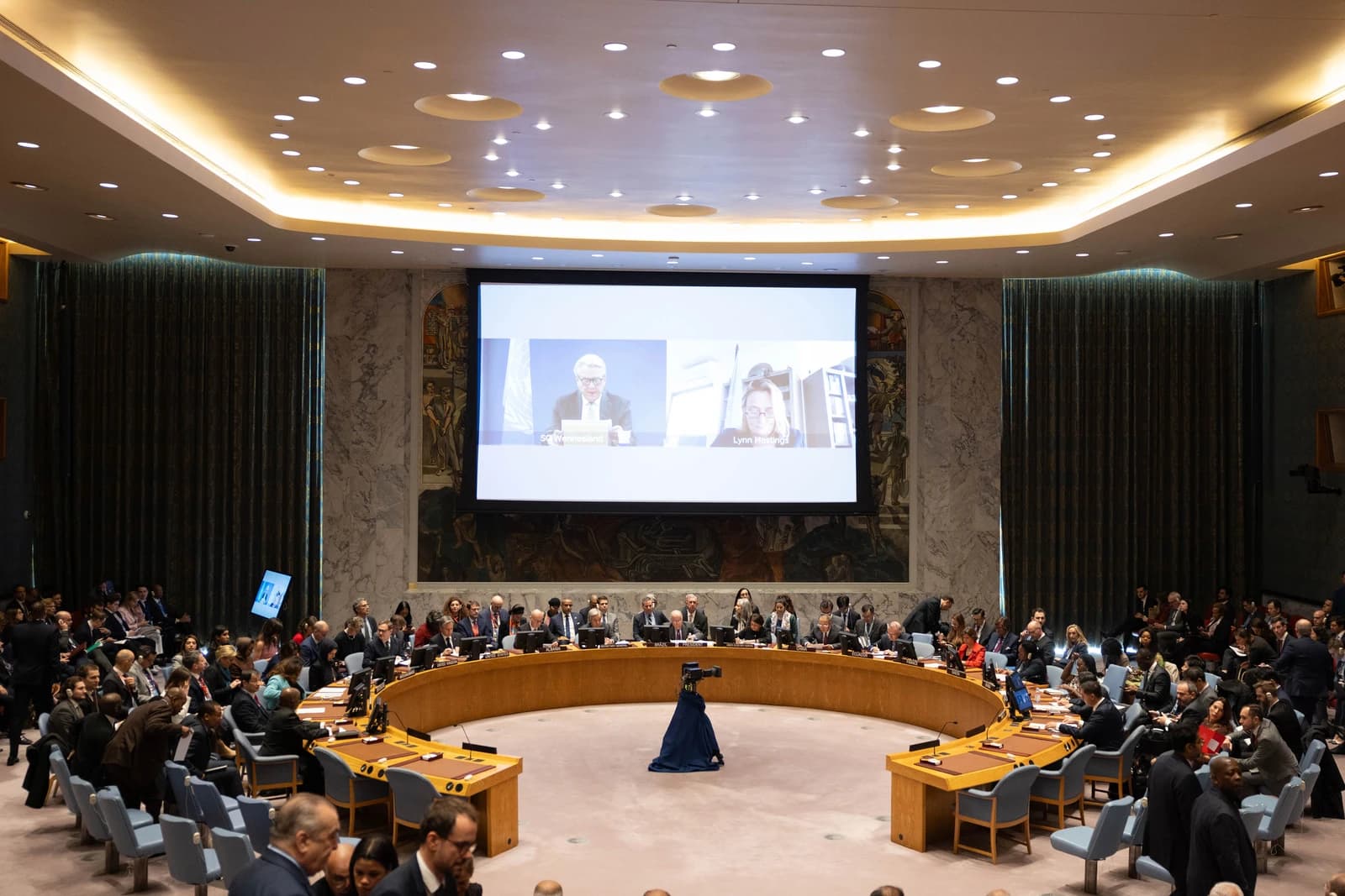 Attendees seated around a large horseshoe-shaped table during a United Nations Security Council meeting.