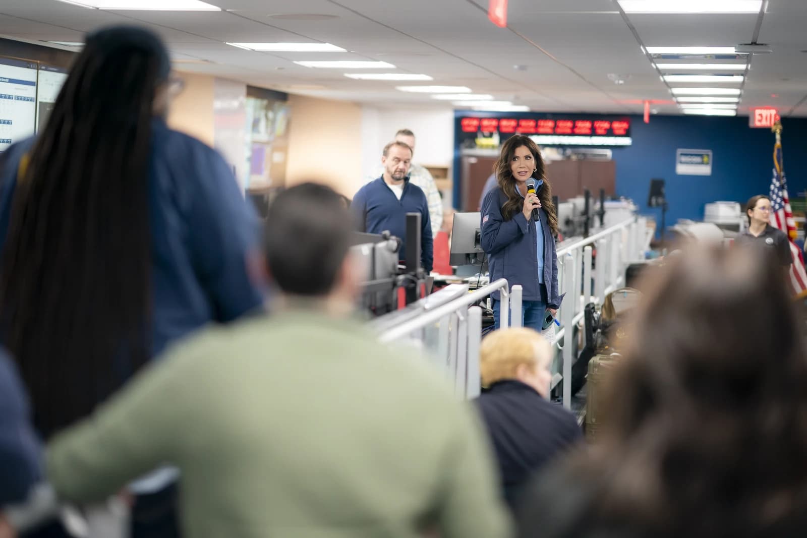 A woman speaks into a microphone at a daily briefing at FEMA headquarters.