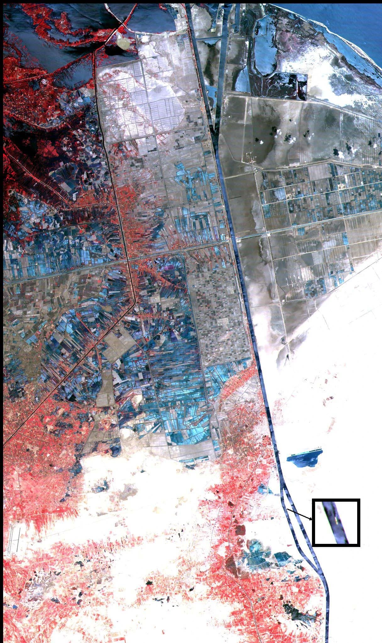 Satellite image of the Suez Canal, showing the waterway surrounded by land.
