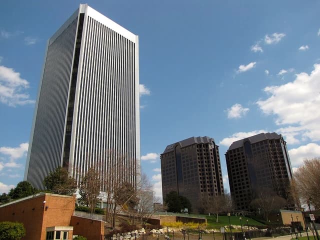 Federal Reserve Bank of Richmond building and two Riverfront Plaza buildings under a blue sky.