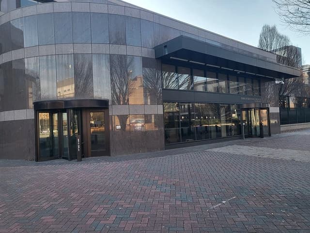 Exterior of Federal Reserve Bank of Richmond Charlotte Branch main entrance on a clear day.