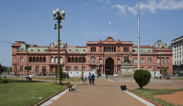 The Casa Rosada, the presidential palace of Argentina, with the Argentine flag flying above.