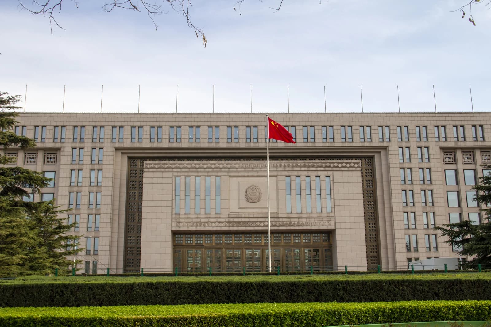 Exterior of the Ministry of Public Security building in China with a red flag.