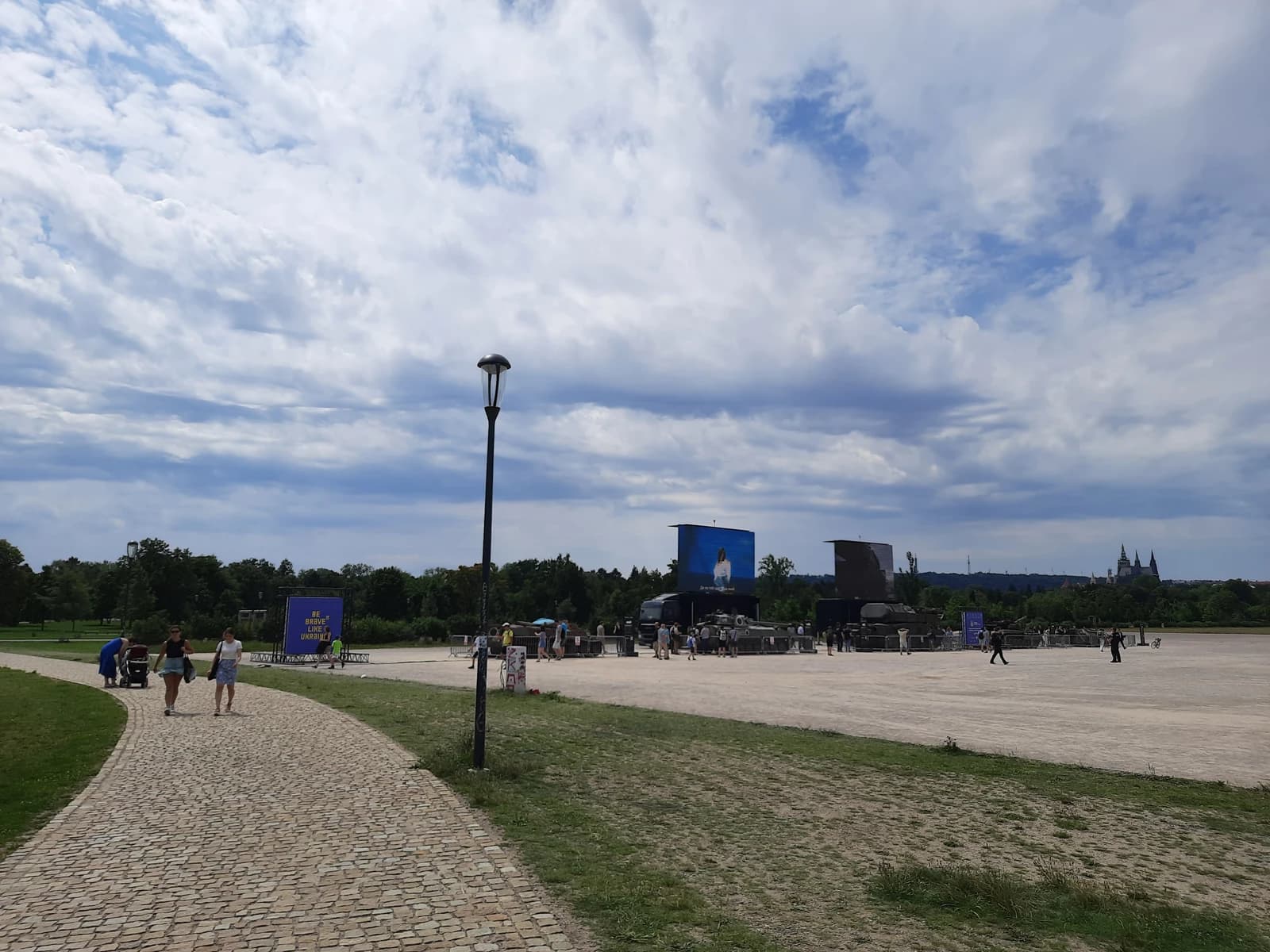 Exhibition in Prague of captured Russian military equipment on display in an open field.