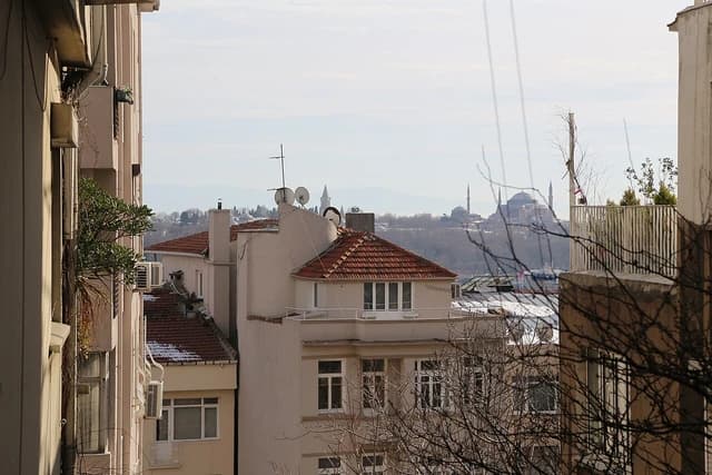 Distant view of Hagia Sophia and Blue Mosque from among residential buildings in Istanbul.