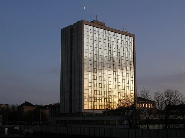 Exterior of the Estonian Ministry of Finance building with a reflection of the setting sun.
