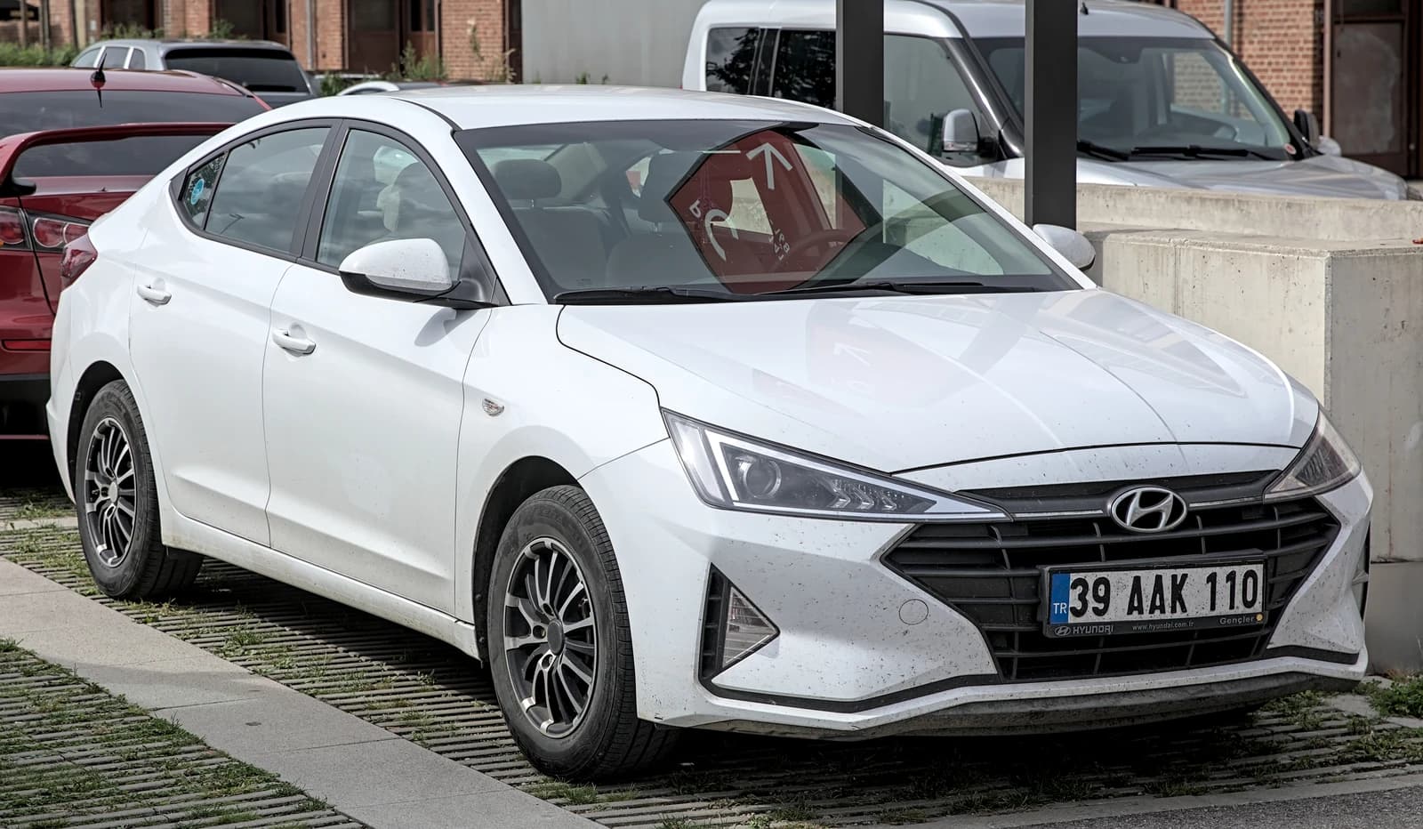 White Hyundai Elantra sedan parked outdoors, displaying a Turkish license plate.