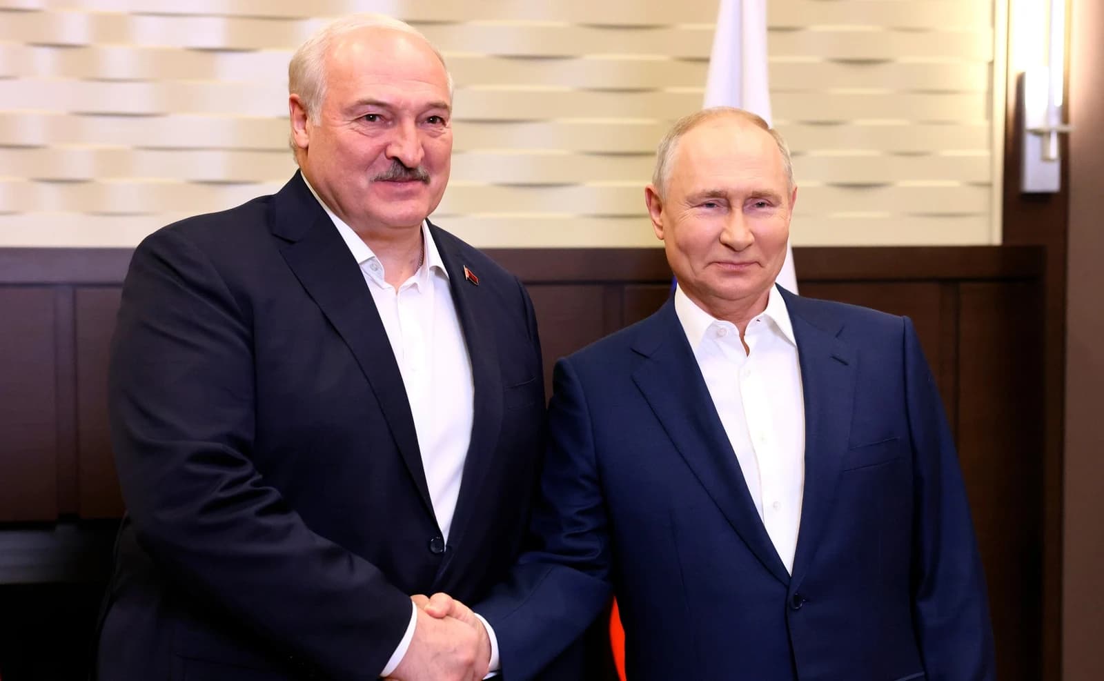 Belarusian President Alexander Lukashenko shaking hands with Russian President Vladimir Putin.