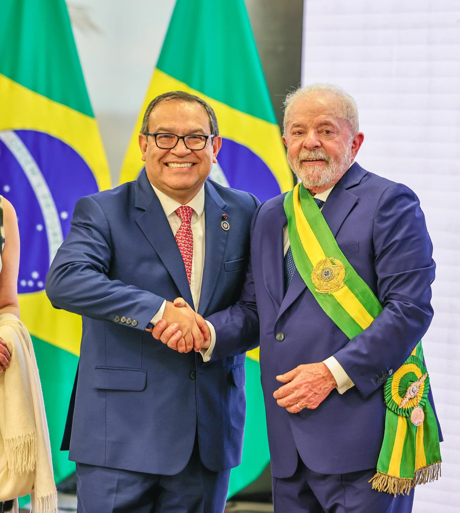 Luiz Inácio Lula da Silva, President of Brazil, shaking hands with a smiling dignitary.