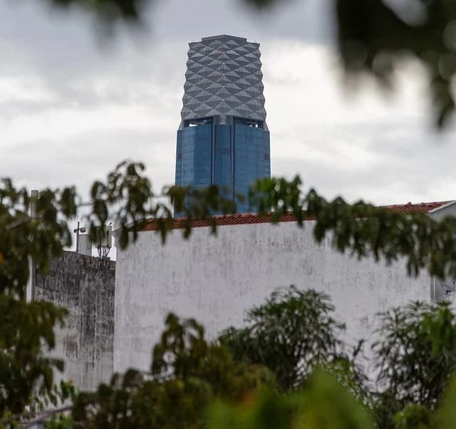 The Exchange 106 skyscraper rises above buildings and trees in Kuala Lumpur.