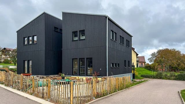 Modern black timber modular duplex house in Deutschland.