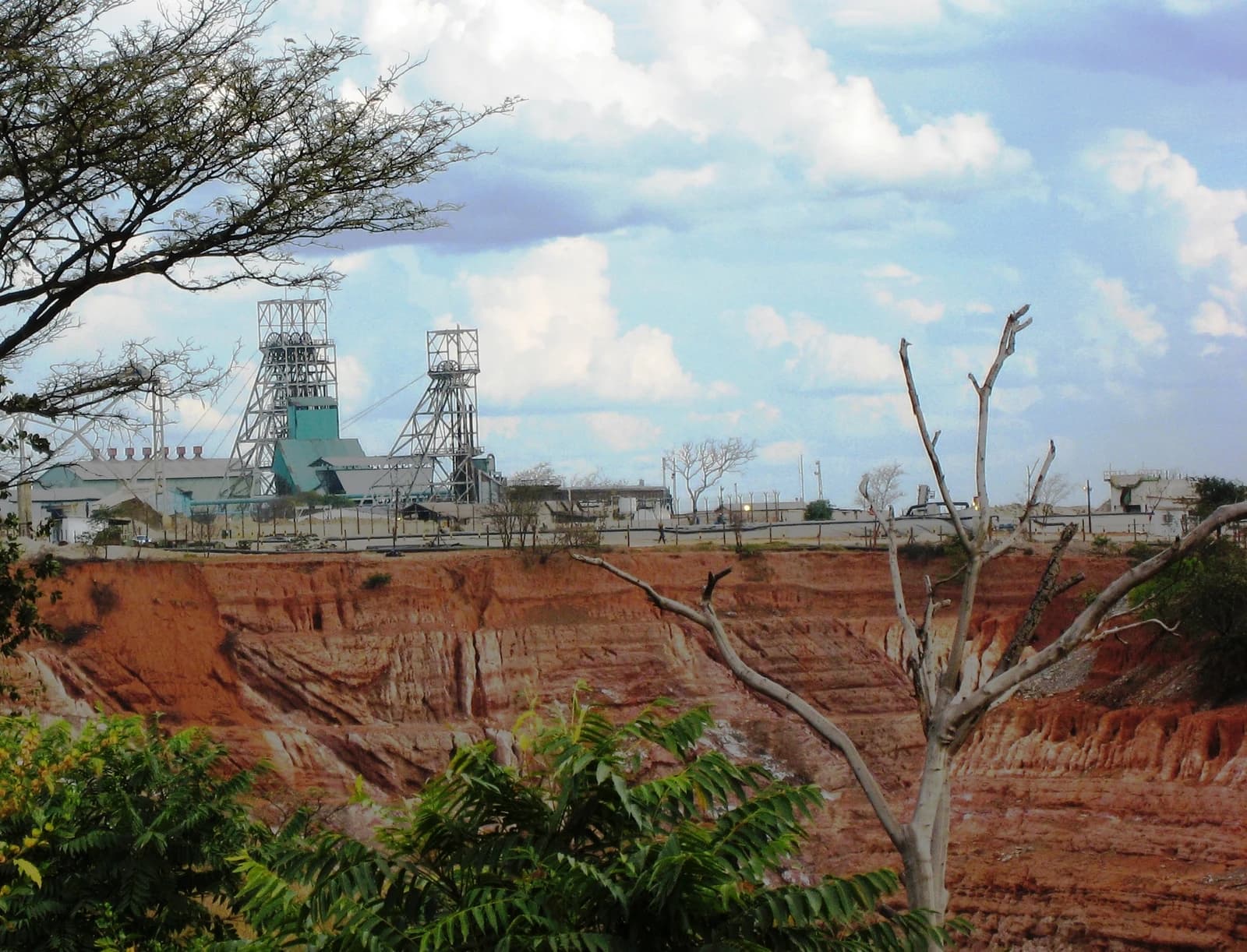 Nkana Mine headgear and buildings with an open pit in the foreground.