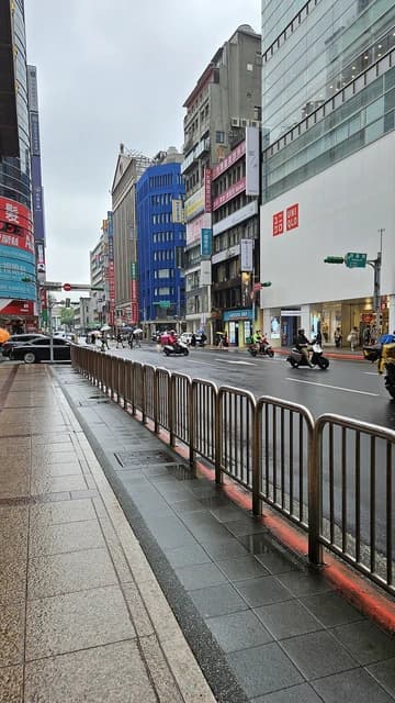 Wet street and buildings on Guanqian Road, Taipei, Taiwan.