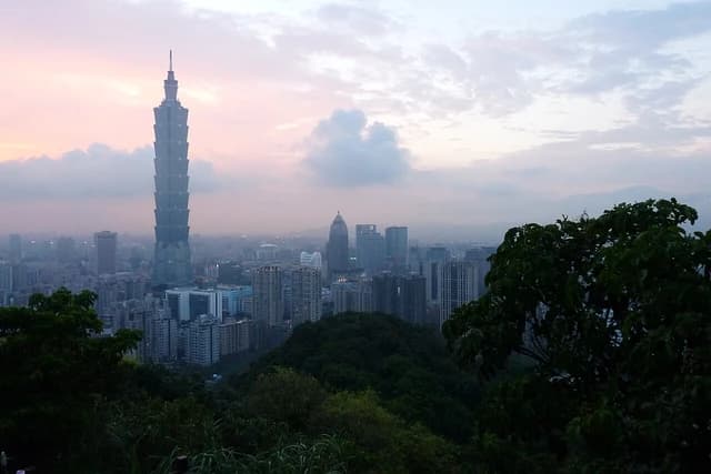 Taipei 101, a tall skyscraper, stands above the city skyline of Taipei.