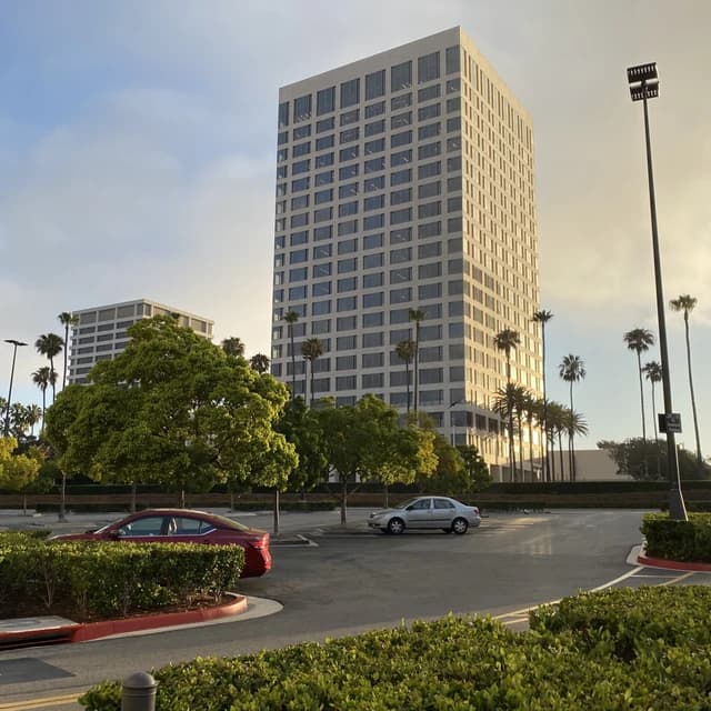 Pimco headquarters building in Newport Beach, California, at sunset.