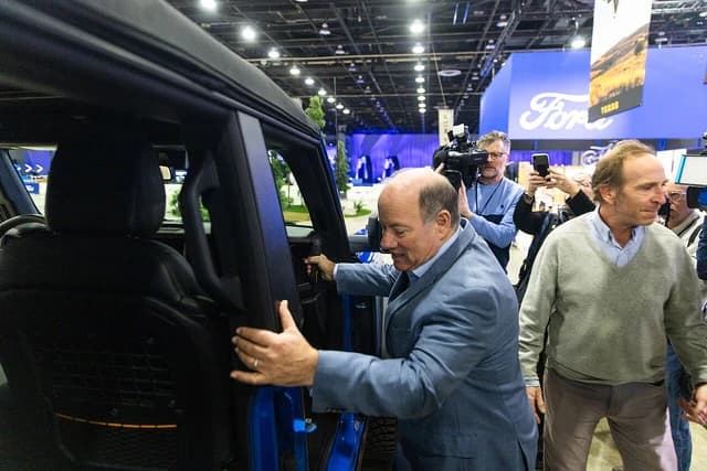 Mike Duggan, Mayor of Detroit, entering a Ford Bronco at an auto show.