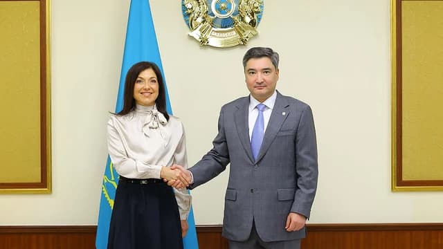 Oljas Bektenov and Katherina Reiche shaking hands during an official meeting.