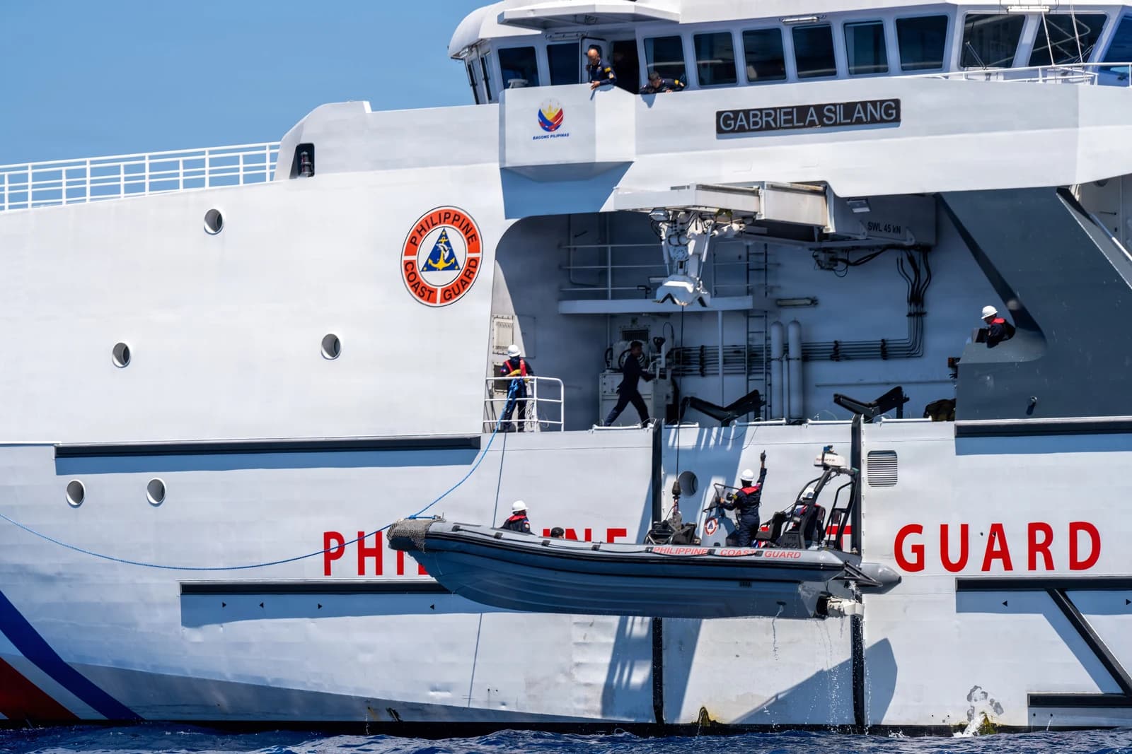 Philippine Coast Guard vessel Gabriela Silang with a small boat being deployed from its side.