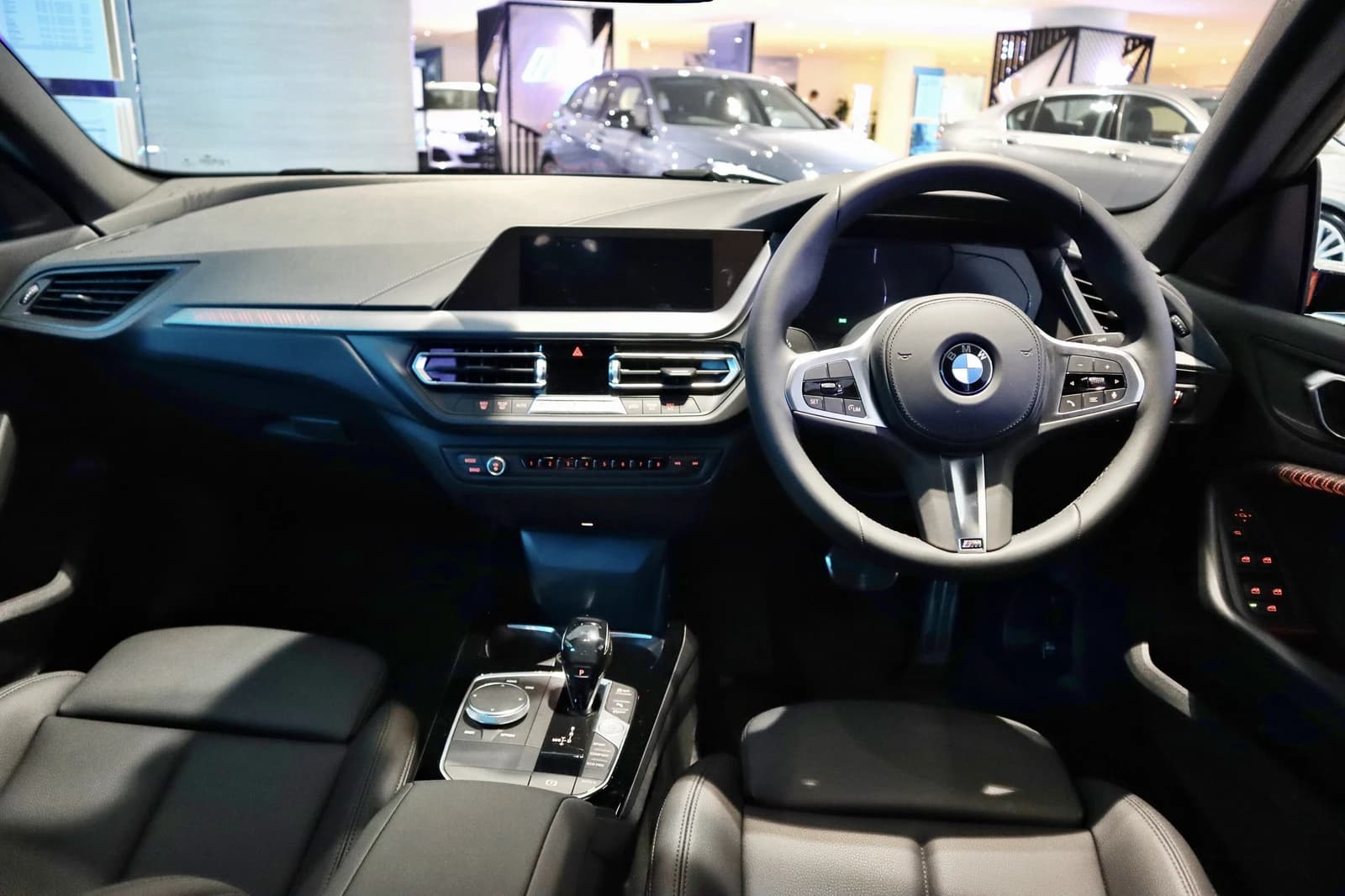 Dashboard and steering wheel of a BMW 2 Series Coupe, showing the interior design.