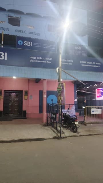 Exterior of the State Bank of India building with signage in Tamil and English.