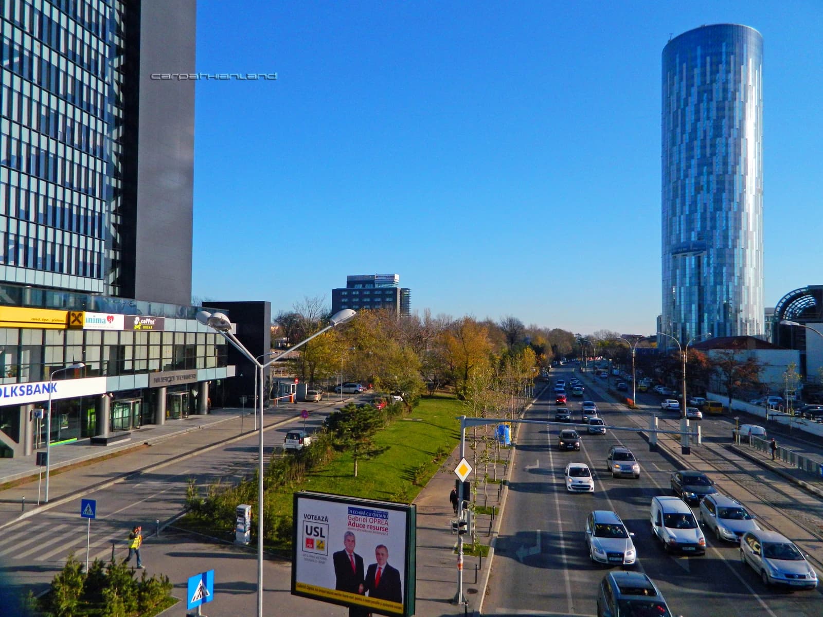 Exterior view of Floreasca SkyTower, a tall cylindrical glass building, in Bucharest.