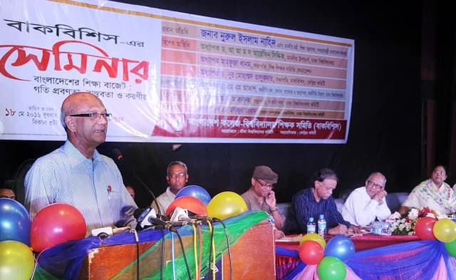 Nurul Islam Nahid, Education Minister, speaks at a podium with microphones.