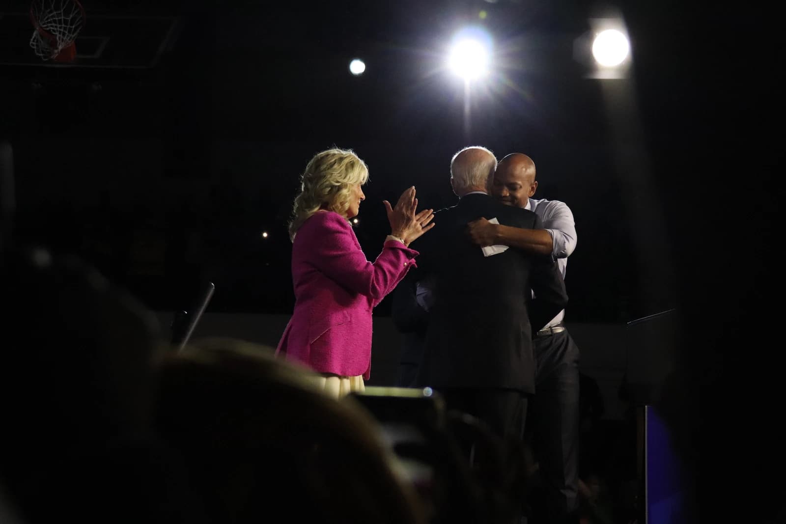 Jill Biden applauds as Joe Biden embraces Wes Moore at an election rally.