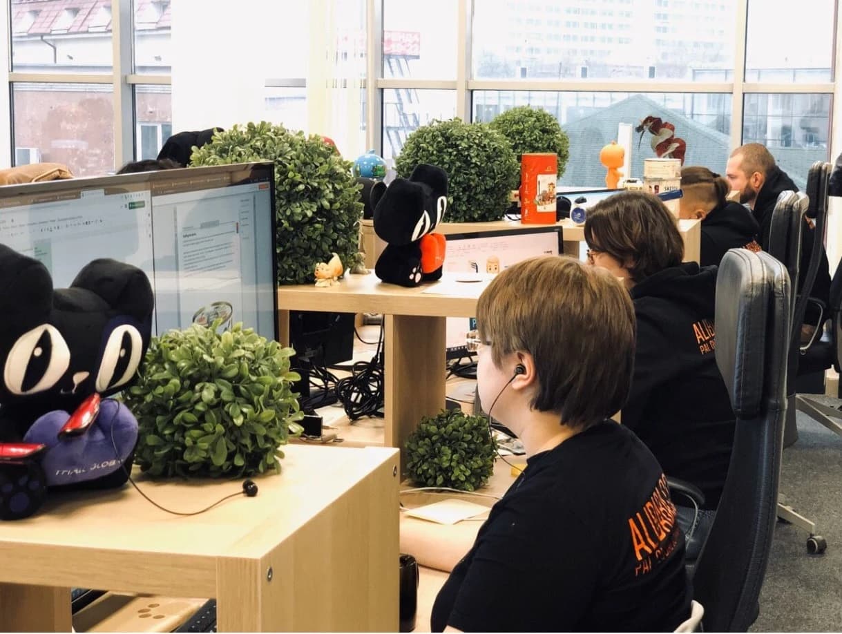People working at their desks in a modern office environment.