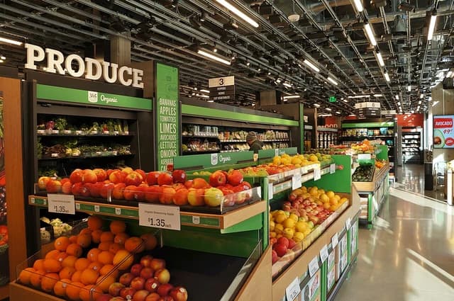 Interior view of an Amazon Go Grocery store featuring aisles of organic produce.