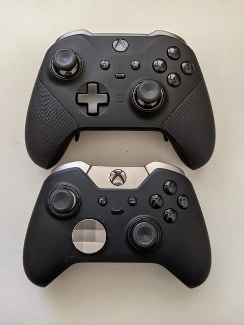 Two black Xbox Elite Series controllers, the Series 2 positioned above the original.