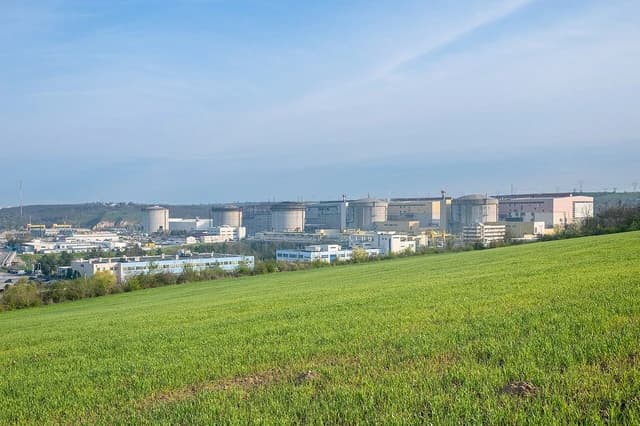 Cernavodă Nuclear Power Plant, Romania, viewed across a green foreground.