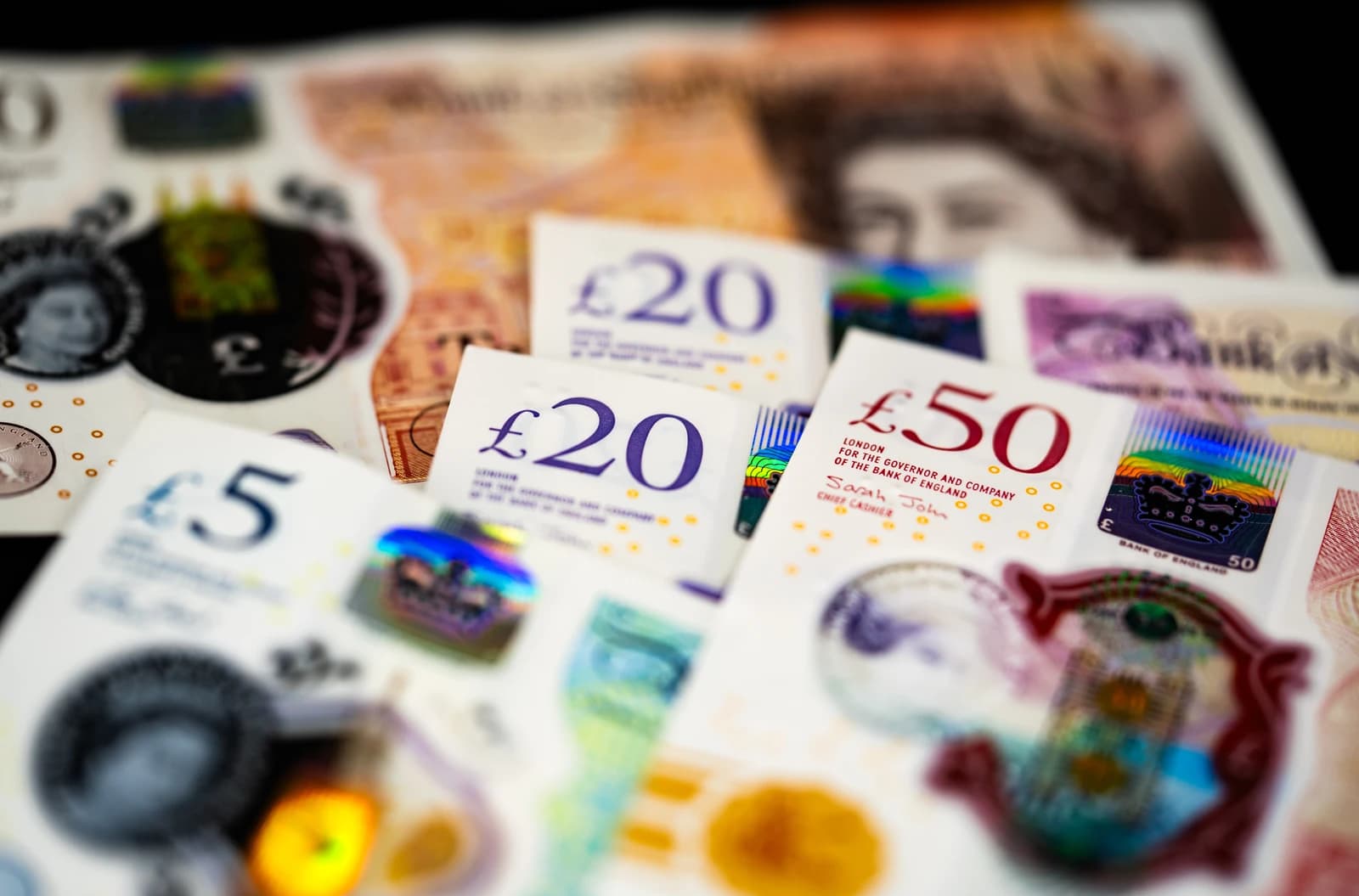 Close-up of British pound sterling banknotes and coins.