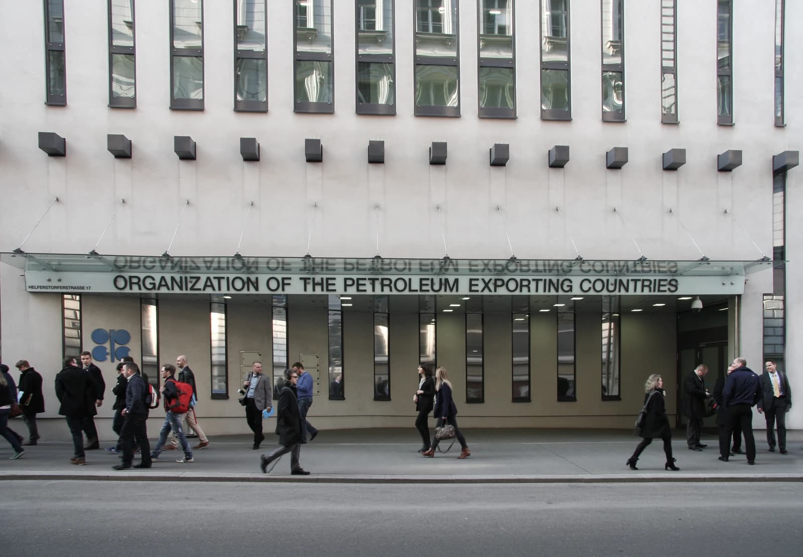 Pedestrians walk outside the entrance to the OPEC Headquarters building in Vienna.