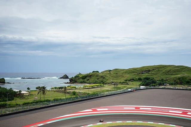 View of Turn 10 at Mandalika International Circuit with coastal landscape.