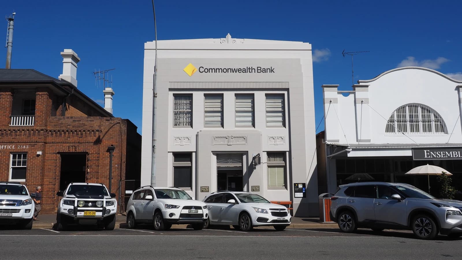 Commonwealth Bank branch in Crookwell, Australia, with parked vehicles in front.