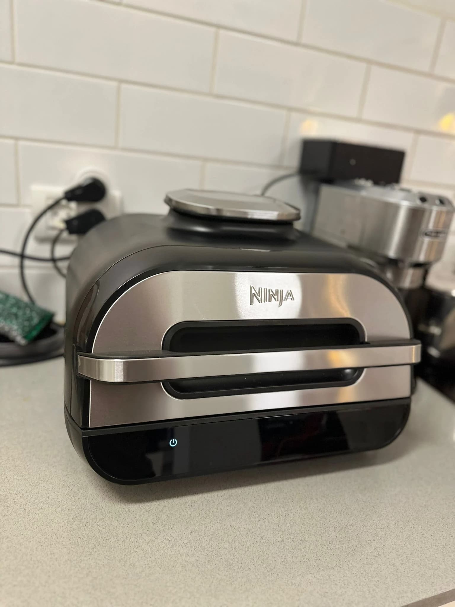 Ninja Foodi MAX Health Grill & Air Fryer, model AG551EU, shown on a kitchen counter.