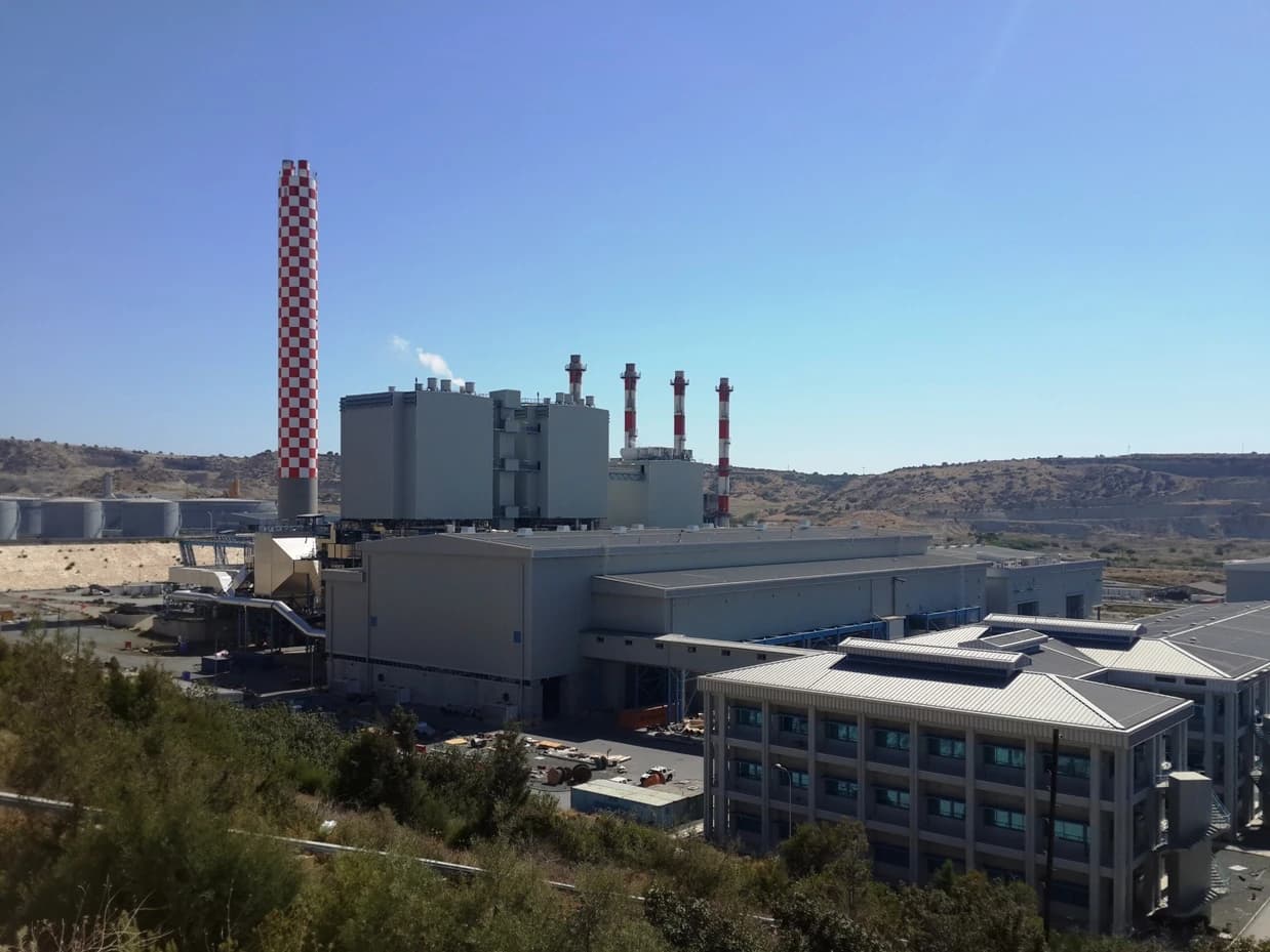 Vasilikos power station in Cyprus with its distinctive red and white smokestack.